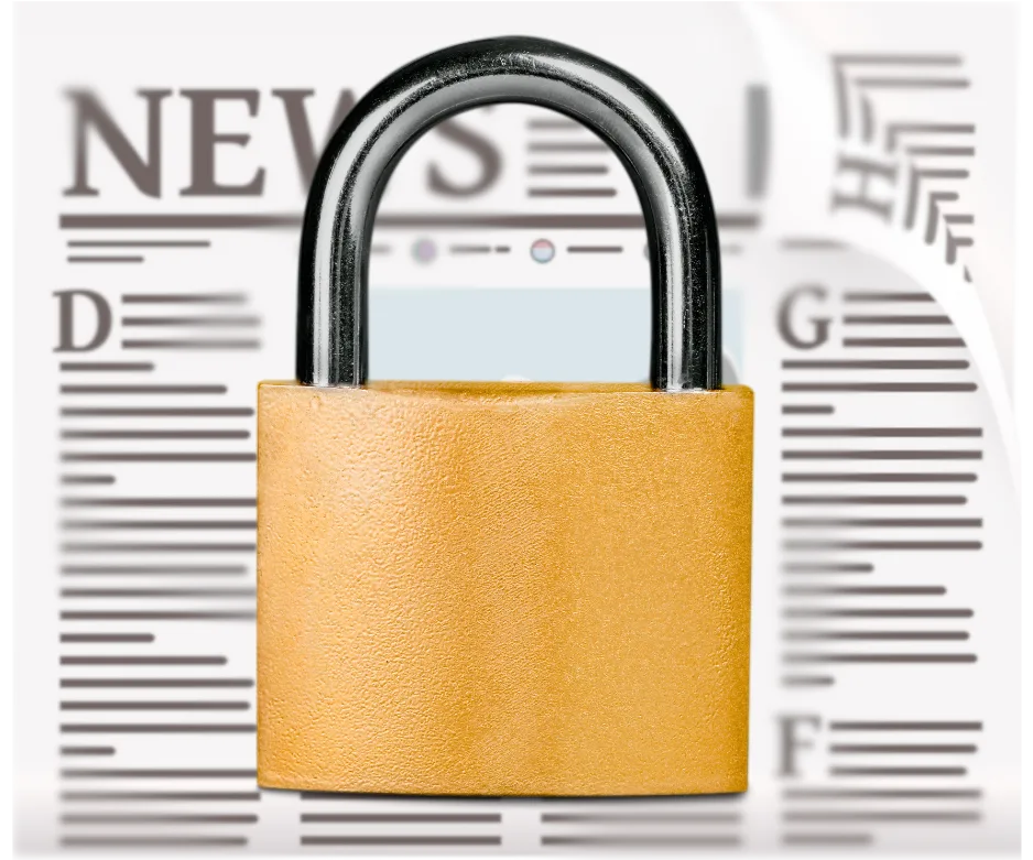 Blurred newspaper behind lock.