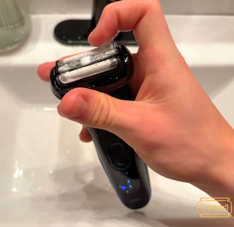 Applying soap to the S5 head over a sink.